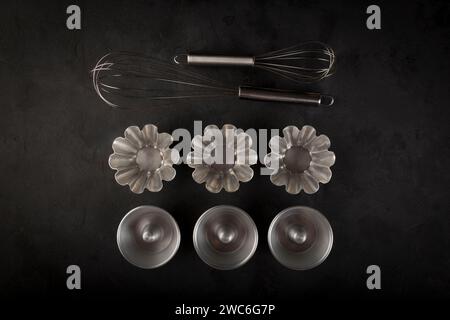 kitchen utensils on black background, seen from above. Stock Photo