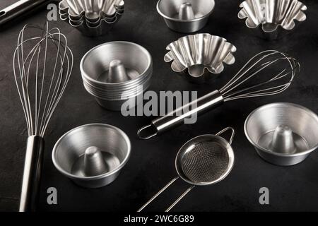 kitchen utensils on black background, seen from above. Stock Photo