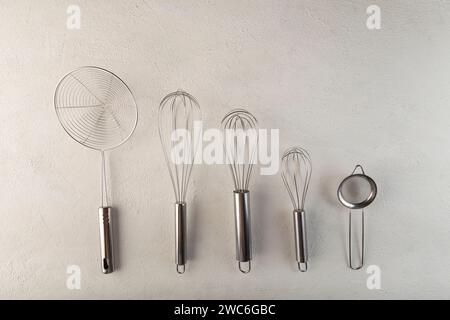 kitchen utensils on light background, seen from above. Stock Photo