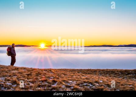 A hill walker on the High Street range in the Lake District National Park, with a cloud inversion / temperature inversion in the distance Stock Photo