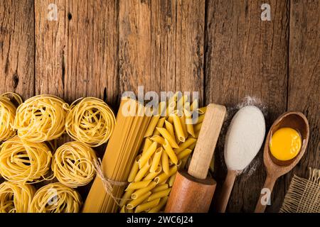 Italian pasta with various ingredients on rustic wooden table. Stock Photo