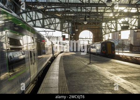 Interior view of Glasgow Central Railway station with two Scotrail trains at the platforms. Train on the left is stationary and the train on the right Stock Photo