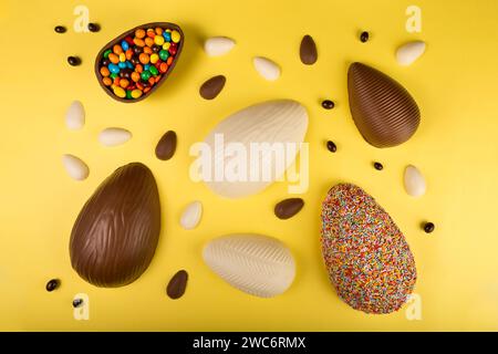 Easter. Composition with chocolate easter eggs on yellow background. Stock Photo