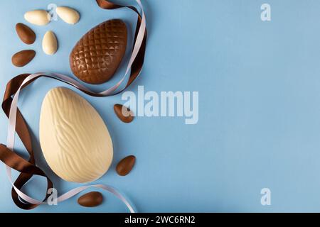 Easter. Composition with chocolate easter eggs on blue background, space for text. Stock Photo