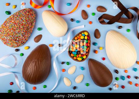 Easter. Composition with chocolate easter eggs on blue background. Stock Photo