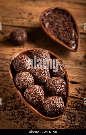 Chocolate Easter eggs stuffed with brigadiers on rustic wooden background. Stock Photo