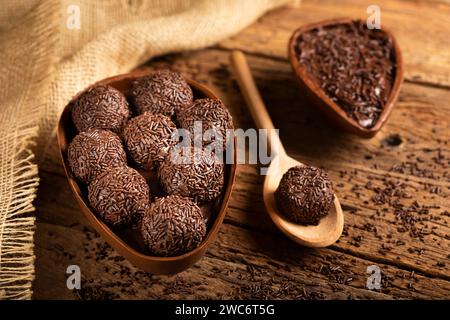 Chocolate Easter eggs stuffed with brigadiers on rustic wooden background. Stock Photo