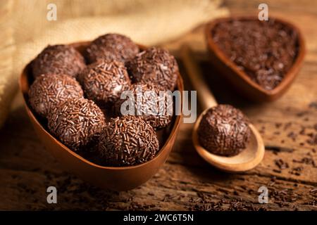 Chocolate Easter eggs stuffed with brigadiers on rustic wooden background. Stock Photo