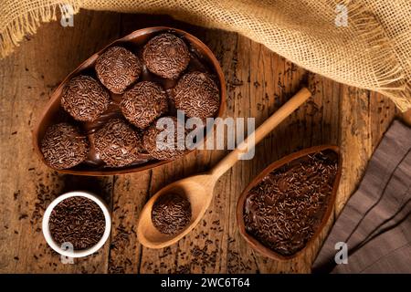 Chocolate Easter eggs stuffed with brigadiers on rustic wooden background. Stock Photo