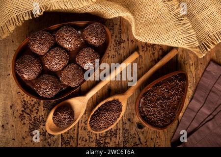 Chocolate Easter eggs stuffed with brigadiers on rustic wooden background. Stock Photo