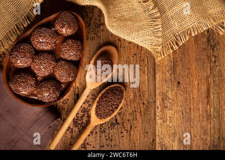 Chocolate Easter eggs stuffed with brigadiers on rustic wooden background. Stock Photo