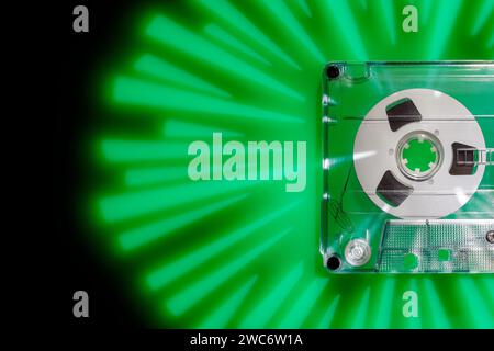 Green light rays projection background, photographed with the help of a gobo mask with a retro audio cassette in 1980s disco music style. There is fre Stock Photo