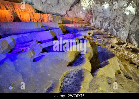 cave formation, undulating rimstone-pools inside illuminated Stopica Cave, Rozanstvo, Serbia Stock Photo