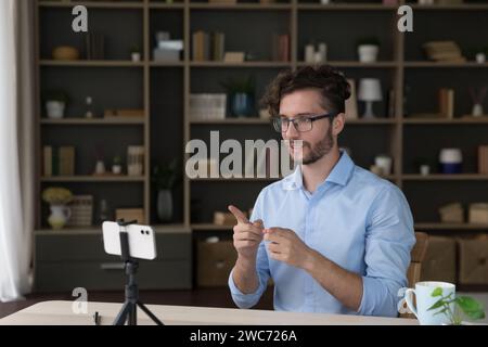 Young man influencer recording new video for vlog using smartphone Stock Photo