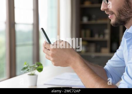 Close up cropped view man using smart phone Stock Photo