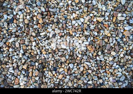 A close-up view of loose gravel scattered on the ground surface Stock Photo