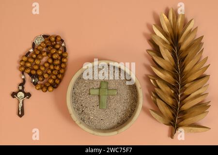 Ash, palm leaf cross, oliver branch. Ash Wednesday concept. Stock Photo