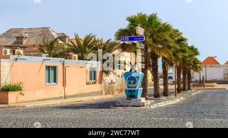 Sal Rei's cobblestone street, lined with vibrant buildings and palms, invites tourists to explore Boa Vista's charm. High quality photo Stock Photo