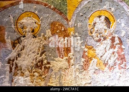 Defaced faces of saints, penciled out faces, carved out faces of Christian saints, frescoes in Goreme open air museum Cappadocia Turkey Stock Photo