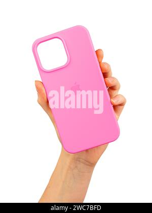 Berlin Germany December 21 2023 Pink phone case in hand. Silicone cover, protector isolated on white Stock Photo