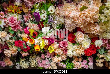 texture or background of many mutlicolored artificial flowers, full frame of flowers Stock Photo