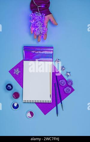 Colorful office still life in Memphis style with a womans hand. Creative tools and accessories in Memphis style. Still life in Memphis style. Stock Photo