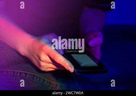 Woman use of cellphone at home. Communicating distantly and using smartphone at home. Stock Photo