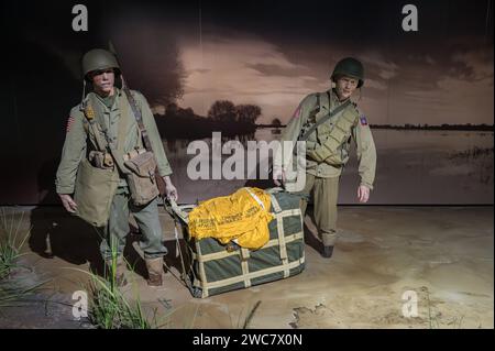 Couple of American airborne soldiers carrying a dropped supply box Stock Photo