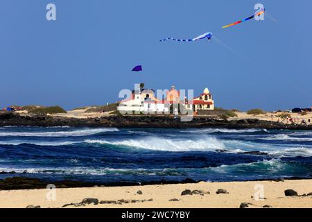 Colourful, large kites at La Concha beach, and the Dream House designed by architect and artist Antonio Padrón Barrera . Taken November 2023 Stock Photo