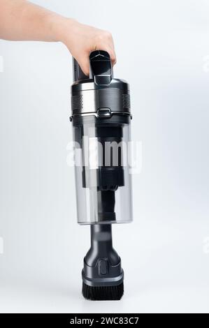 Rechargeable portable vacuum cleaner in hand close up view isolated on white studio background Stock Photo