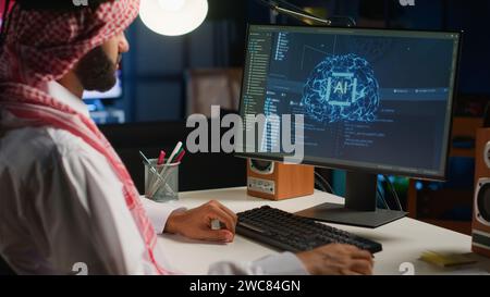 IT executive updating AI systems using computer, writing binary code scripts. Technical support consultant working from home using programming to upgrade artificial intelligence simulation model Stock Photo