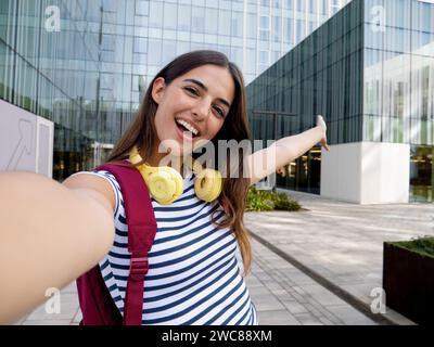 POV of a smiling teenage girl influencer talking to the camera while doing a live stream for social networks Stock Photo