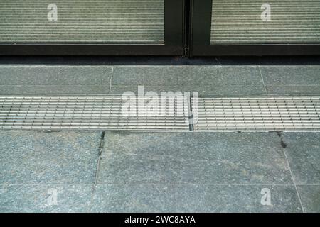 type of grate or grate used in a drainage system to allow water to pass through. manhole, grate water drain, Stock Photo