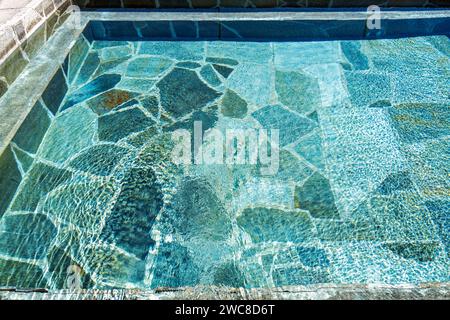 The abstract patterns in a pool with natural stone tiles Stock Photo