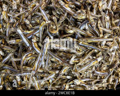 Beautiful top view of Dried anchovy texture background. Seafood in the market. Stock Photo