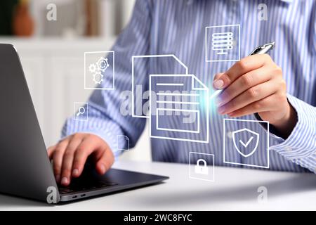 File system. Woman with laptop at table, closeup. User organizing folders and documents on virtual screen Stock Photo