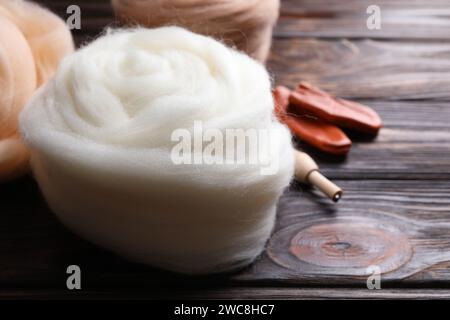 Colorful felting wool on wooden table, closeup. Space for text Stock Photo