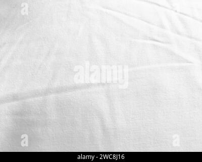 An exquisite cloth material in a bright, white hue, its smooth and silky surface evoking a sense of luxury and quality for a sophisticated background. Stock Photo