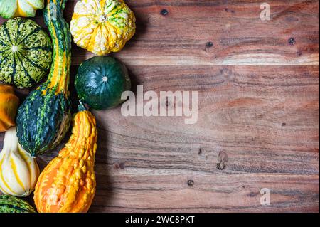 Variety of gourds on left side of wood cutting board Stock Photo