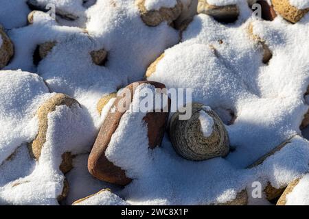 Stones covered by fresh snow. Winter background Stock Photo