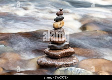 Stacked balanced stones in the Findhorn river in winter. Morayshire, Scotland Stock Photo