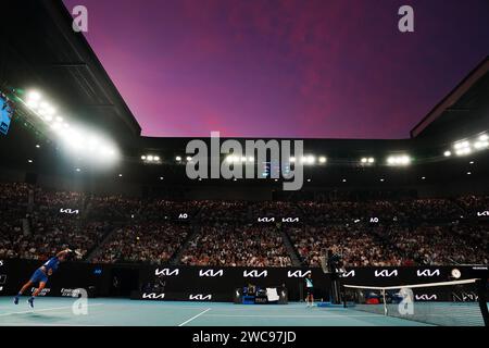 Melbourne, Australia. 14th Jan, 2024. Novak Djokovic of Serbia serves to Dino Prizmic of Croatia during their men's singles 1st round match at Australian Open tennis tournament in Melbourne, Australia, Jan. 14, 2024. Credit: Wang Shen/Xinhua/Alamy Live News Stock Photo