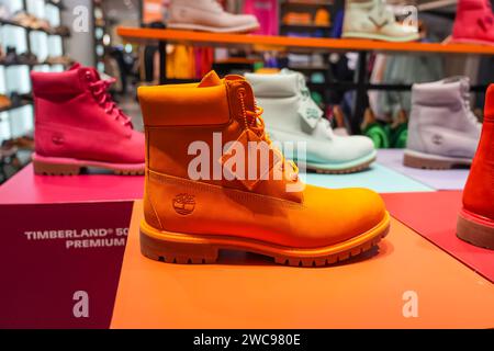 Orange boots Timberland 50th edition booth premium multi colorful bright shoes. Thailand, Bangkok 21 december 2024. Stock Photo