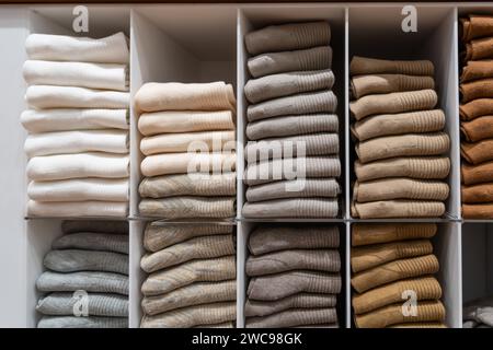 Stacks of socks and models of various colors pastel calm shades on a store shelf. Stock Photo