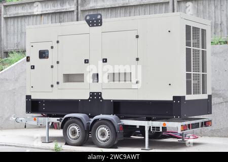 Industrial generator power. Mobile diesel backup generator on caravan wheels.  Backup power supply generator for emergency. Stock Photo