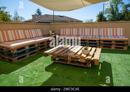 garden wooden table sit bench made from wooden recycle storage pallet diy on home garden terrace house Stock Photo