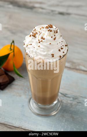 Orange and chocolate milkshake with coffee sprinkled on top Stock Photo