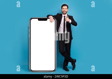 Full body length size cadre of positive successful thumb up rate feedback web page panel screen phone isolated on blue color background Stock Photo