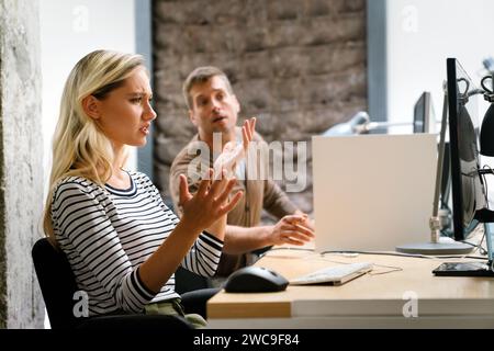 Portrait of a disappointed woman programmer looking stressed out while working on a computer code Stock Photo