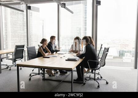 Multiethnic business team working on project, talking at table Stock Photo